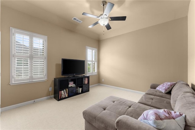 carpeted living area with a ceiling fan, baseboards, and visible vents