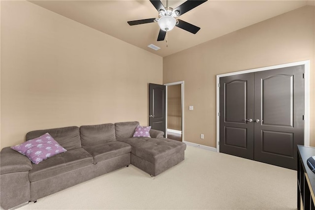 living room with carpet flooring, a ceiling fan, baseboards, and visible vents