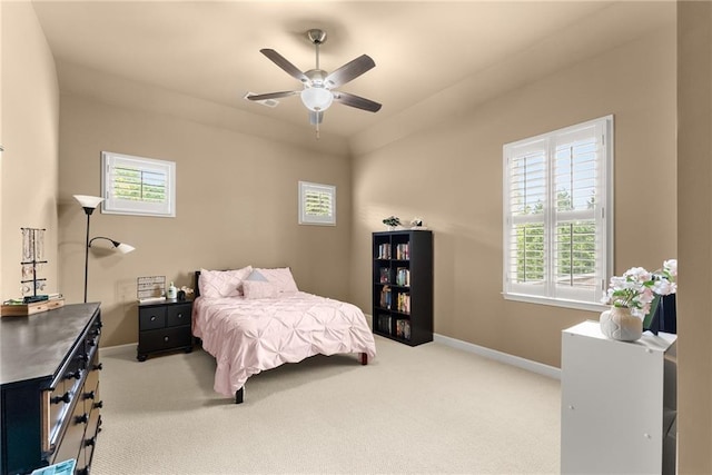 carpeted bedroom with a ceiling fan and baseboards