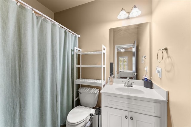 ensuite bathroom with vanity, toilet, and connected bathroom