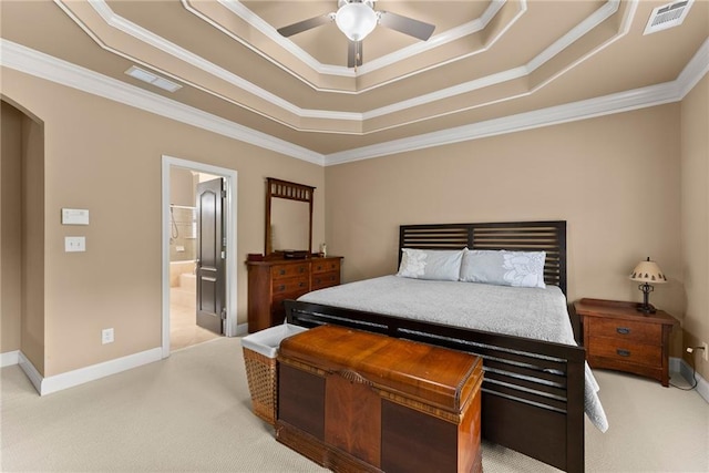 bedroom featuring visible vents, crown molding, light colored carpet, a tray ceiling, and arched walkways