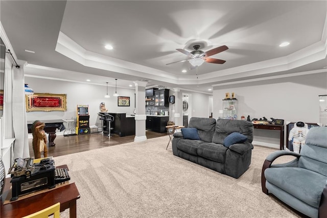 living room with indoor bar, a ceiling fan, recessed lighting, and a raised ceiling