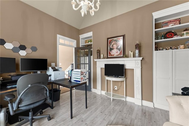 office space with baseboards, a chandelier, wood finished floors, and lofted ceiling