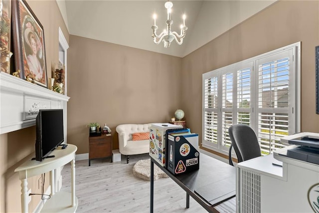 office space featuring high vaulted ceiling, an inviting chandelier, baseboards, and light wood-style floors