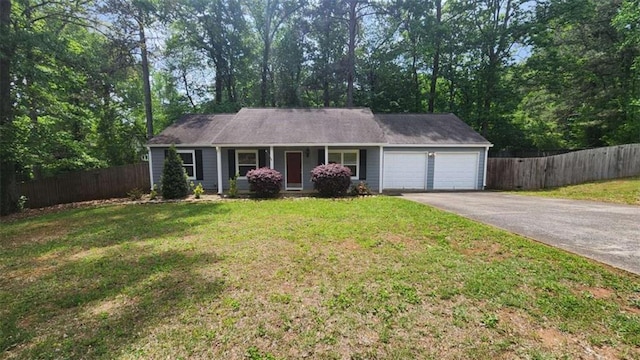 ranch-style home featuring a front yard, driveway, a garage, and fence