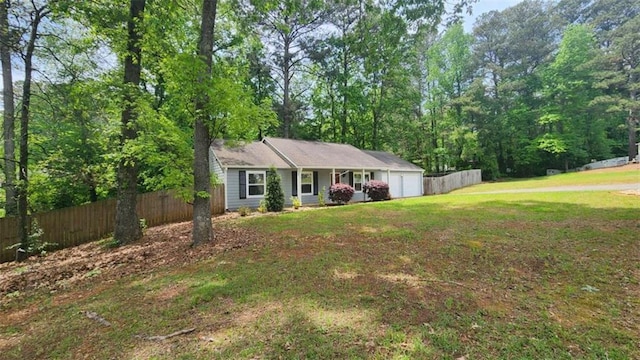 ranch-style house with a front lawn, a garage, and fence