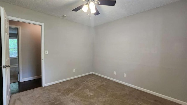 unfurnished room with a textured ceiling, ceiling fan, baseboards, and carpet floors