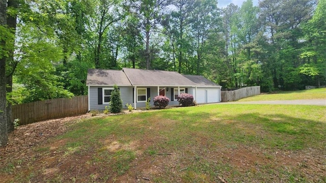 single story home featuring a porch, a front yard, a garage, and fence