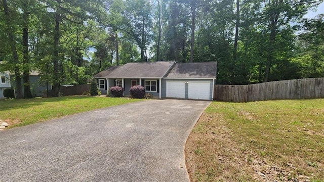 single story home with a front lawn, an attached garage, aphalt driveway, and fence