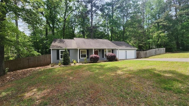 single story home featuring a front lawn, a garage, covered porch, driveway, and fence