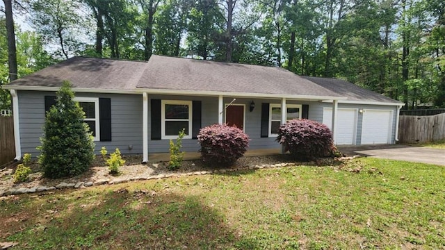 single story home featuring a porch, a front lawn, concrete driveway, an attached garage, and fence
