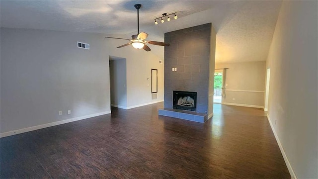unfurnished living room with ceiling fan, vaulted ceiling, wood finished floors, and baseboards