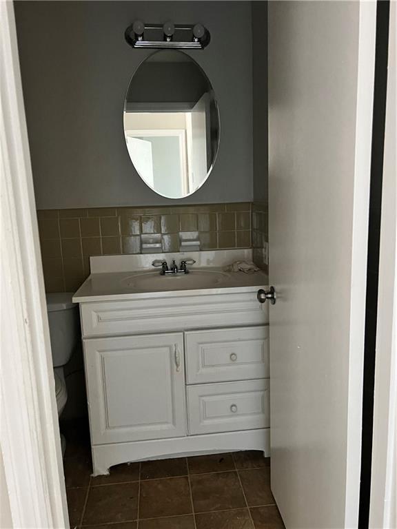 bathroom featuring tile patterned flooring, vanity, and toilet