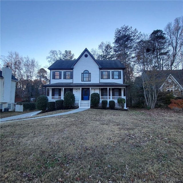 view of front facade with a front lawn and a porch