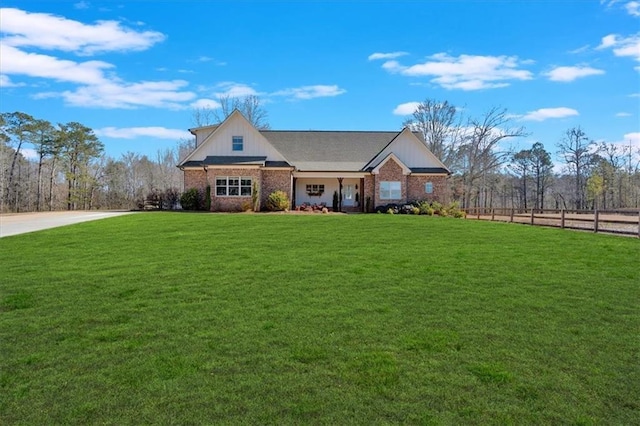 view of front of house with a front lawn and brick siding