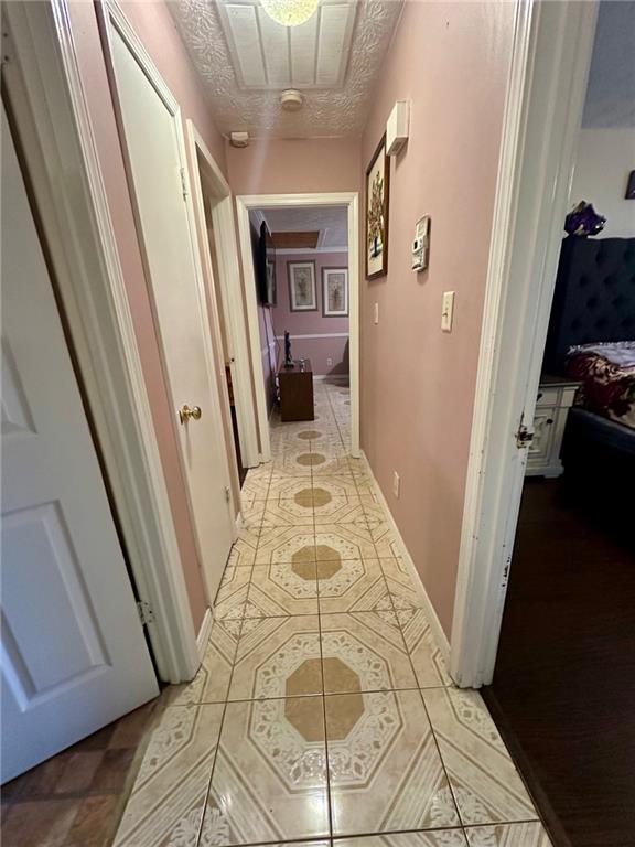 hallway featuring a textured ceiling