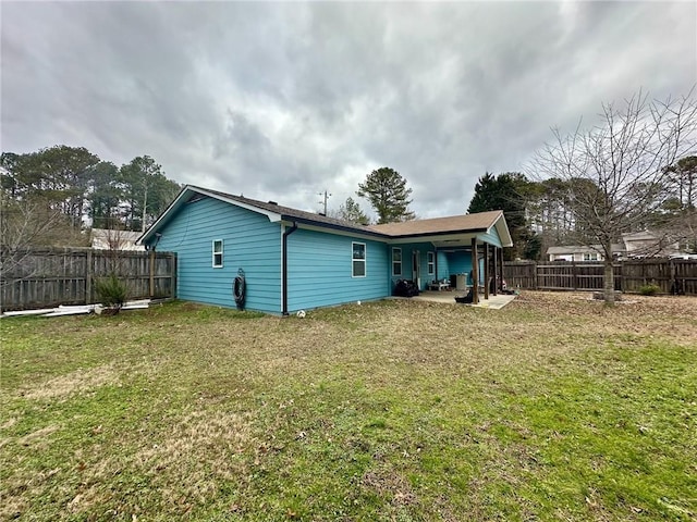 back of house featuring a patio and a lawn