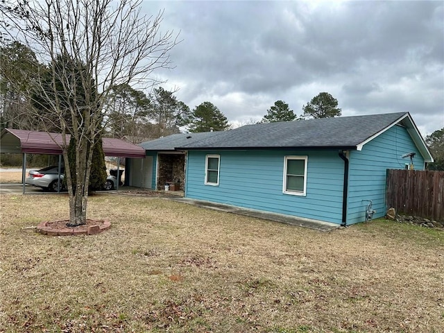 exterior space with a carport and a yard