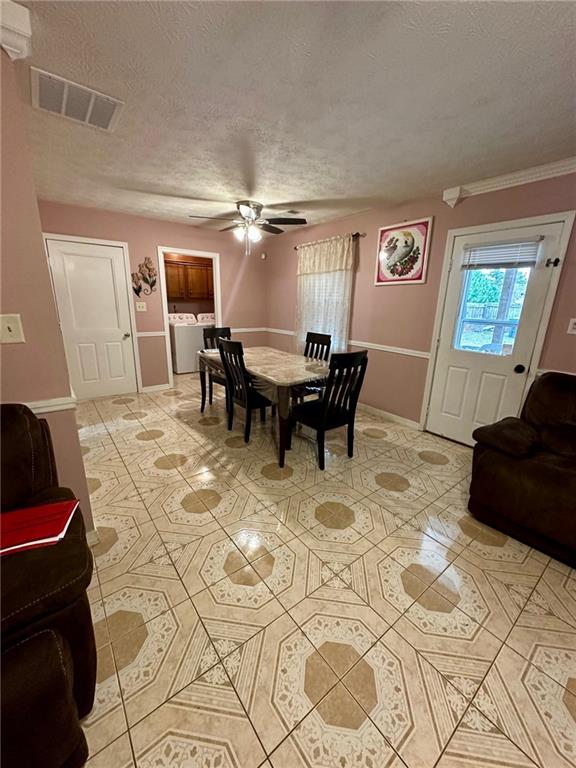 dining room featuring crown molding, ceiling fan, and a textured ceiling