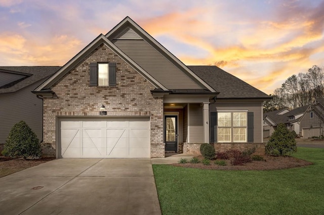 craftsman inspired home with a garage and a yard