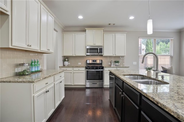 kitchen with white cabinetry, appliances with stainless steel finishes, and a sink