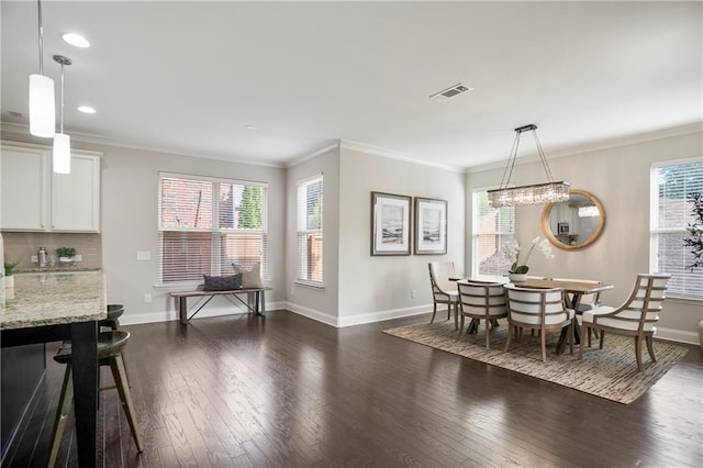 dining area featuring visible vents, baseboards, dark wood-style floors, and crown molding