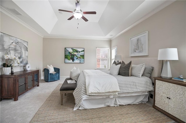 bedroom featuring visible vents, a tray ceiling, carpet flooring, baseboards, and ceiling fan