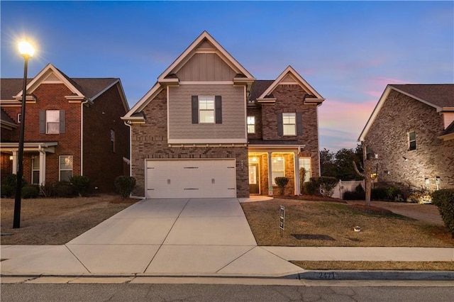 view of front facade featuring a garage, brick siding, board and batten siding, and concrete driveway