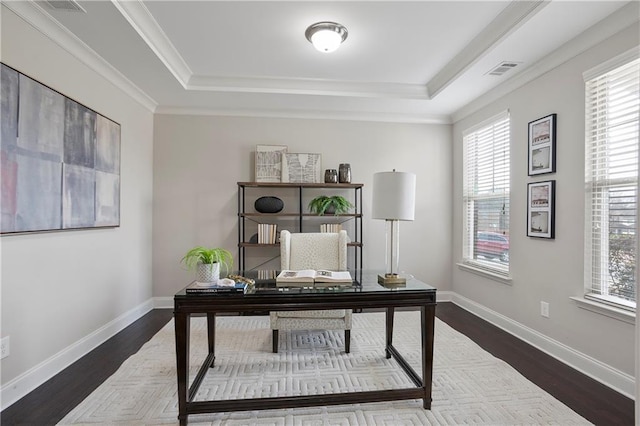 office featuring a tray ceiling, baseboards, dark wood-type flooring, and visible vents