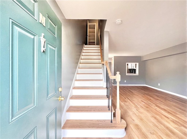 stairs featuring hardwood / wood-style flooring