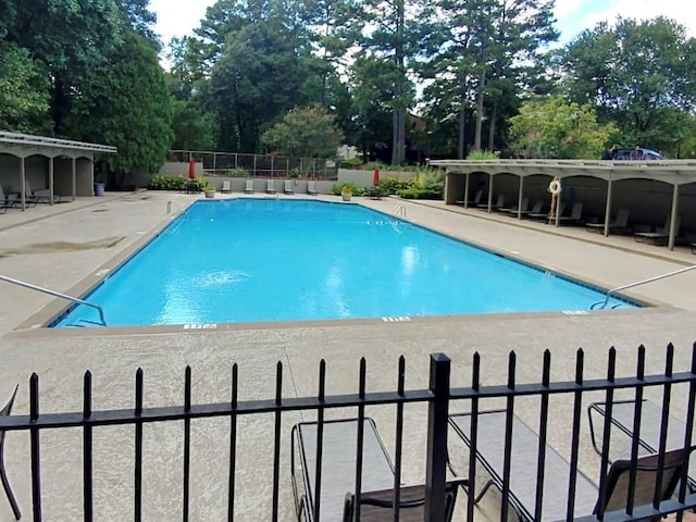 pool featuring a patio and fence