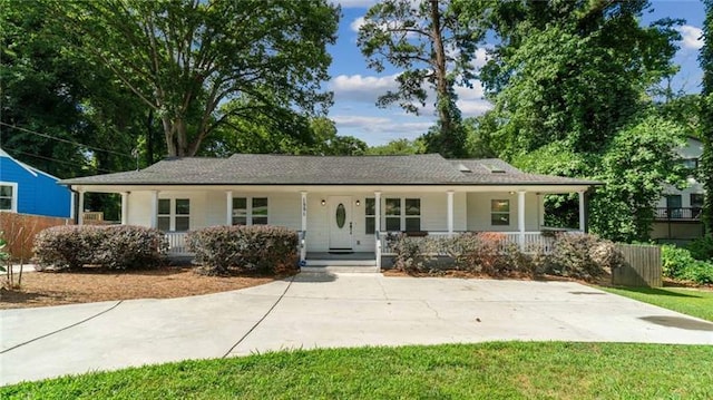 ranch-style home with covered porch and fence