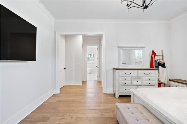 bedroom featuring light wood finished floors, baseboards, crown molding, and an inviting chandelier