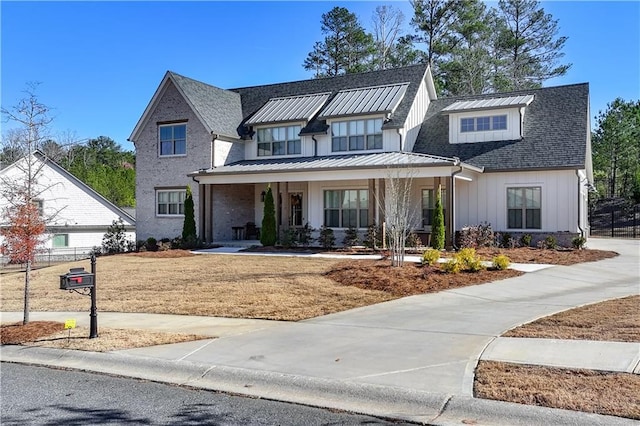 modern farmhouse style home featuring a standing seam roof, metal roof, and board and batten siding