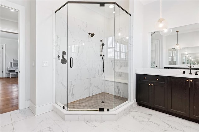 bathroom featuring marble finish floor, a marble finish shower, and vanity