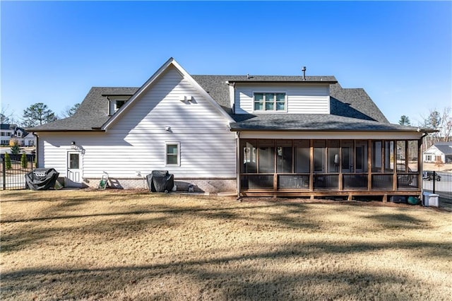 back of house featuring a sunroom, fence, and a yard