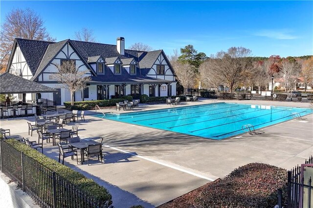 pool featuring fence and a patio