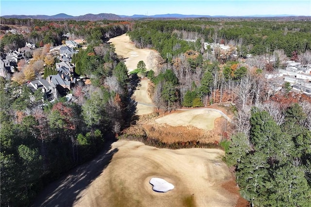 birds eye view of property featuring a forest view and a mountain view