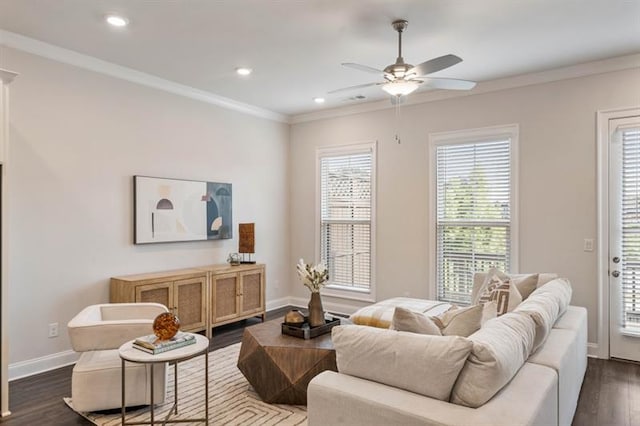 living room featuring ceiling fan, crown molding, dark hardwood / wood-style flooring, and a healthy amount of sunlight