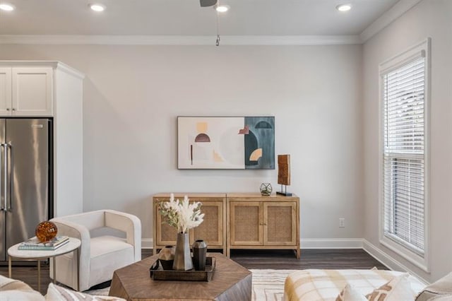 living room with dark hardwood / wood-style floors and crown molding