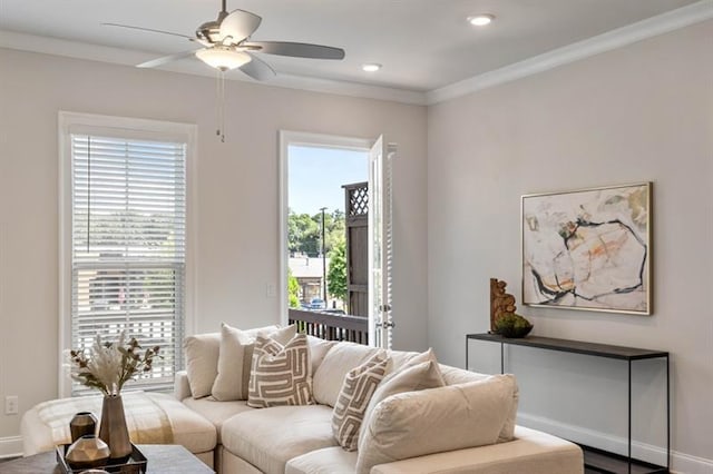 living room featuring a wealth of natural light, ceiling fan, and ornamental molding