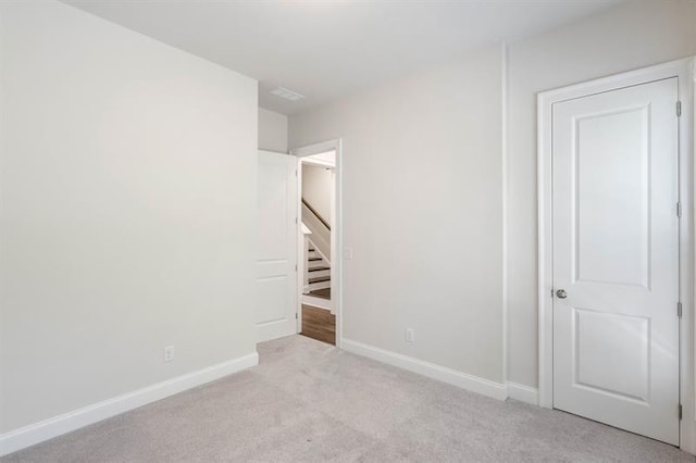 unfurnished bedroom featuring light colored carpet