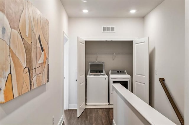 washroom with independent washer and dryer and dark hardwood / wood-style floors