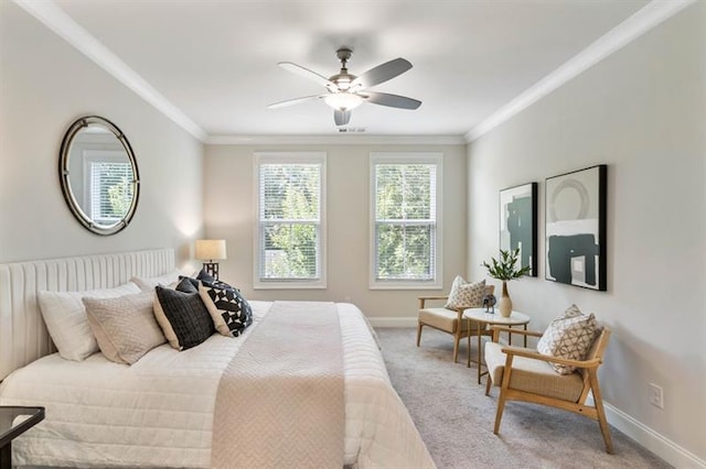 carpeted bedroom featuring ceiling fan and crown molding