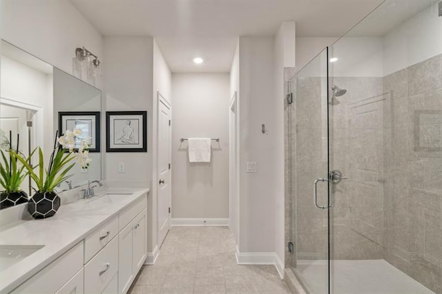 bathroom with tile patterned floors, a shower with door, and vanity