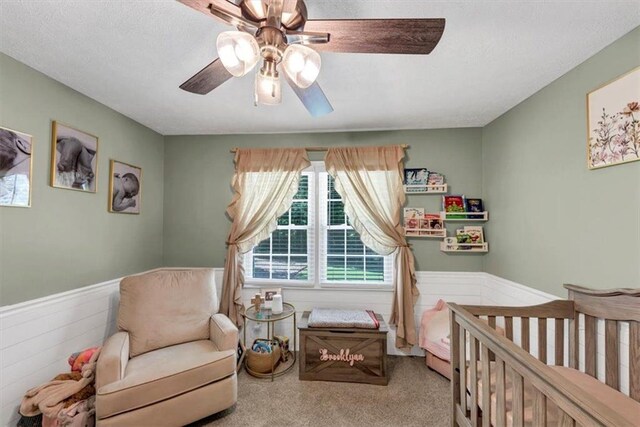 586 Old Bushmill Rd, Bremen, GA 30110 - carpeted bedroom featuring multiple windows, a wainscoted wall, a nursery area, and a ceiling fan