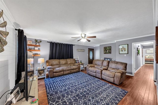 586 Old Bushmill Rd, Bremen, GA 30110 - living room featuring crown molding, ceiling fan, wood-type flooring, baseboards, and a textured ceiling