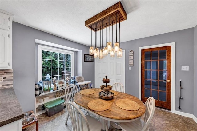 586 Old Bushmill Rd, Bremen, GA 30110 - dining room with a chandelier, a textured ceiling, and baseboards