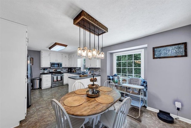 586 Old Bushmill Rd, Bremen, GA 30110 - dining space with a textured ceiling and baseboards