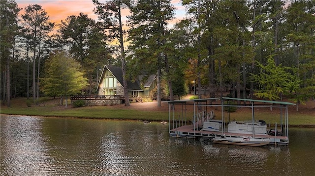 view of dock featuring a yard and a water view